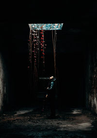 Rear view of man walking on street at night