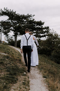 Rear view of man walking on field