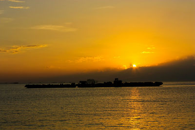 Scenic view of sea against orange sky