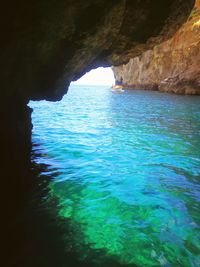 Scenic view of sea seen through cave