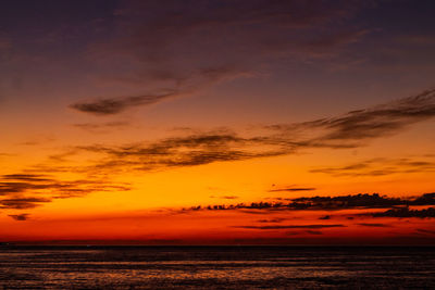 Scenic view of sea against romantic sky at sunset