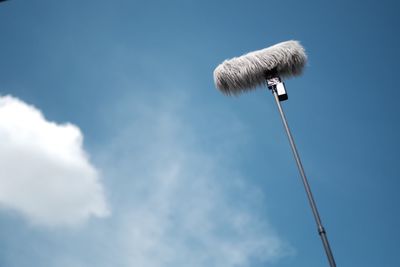 Low angle view of microphone against sky