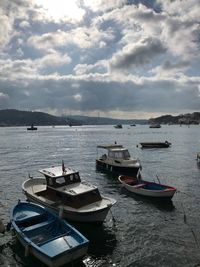 Boats moored on sea against sky