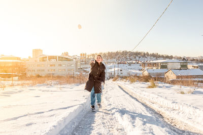 Man standing on snow against sky during winter