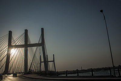 Low angle view of suspension bridge against sky
