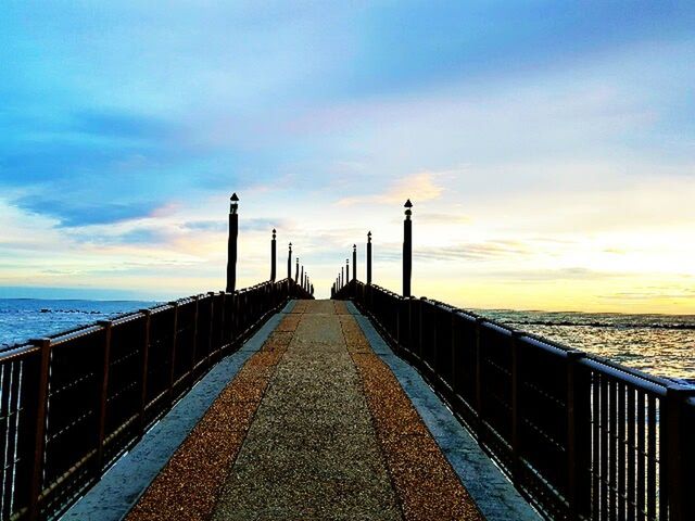 PIER AMIDST SEA AGAINST SKY