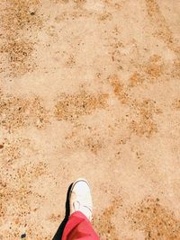 Low section of person standing on tiled floor