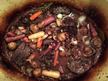 Close-up of vegetables with meat cooking in container