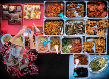 Directly above shot of woman standing at food stall