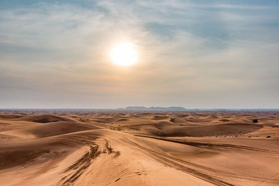 Scenic view of desert against sky during sunset