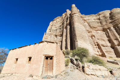 Historic church amidst andes mountains on sunny day