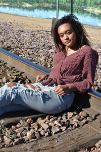 Beautiful young woman sitting at beach