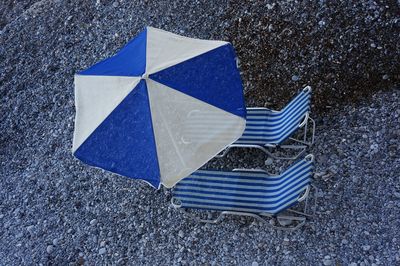 Umbrella and chairs on pebble beach