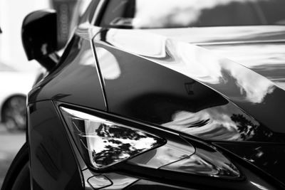 Close-up of sunglasses on side-view mirror