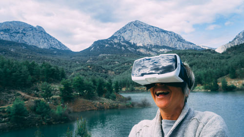 Portrait of man in lake against mountains