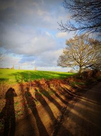 Scenic view of field against cloudy sky