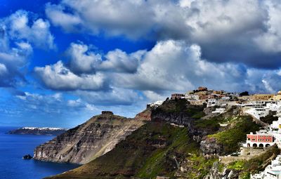 Scenic view of sea and mountains against sky