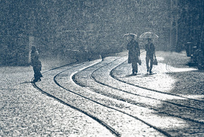 People walking on street during monsoon