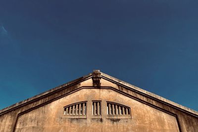 Low angle view of building against blue sky