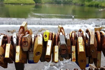 Close-up of padlocks on metal by river