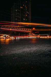 Light trails on bridge in city at night