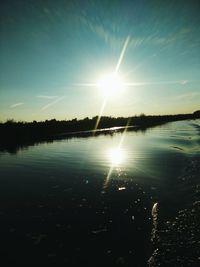 Sun shining over calm lake