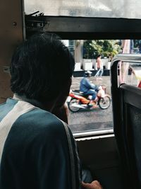 Rear view of woman sitting in car