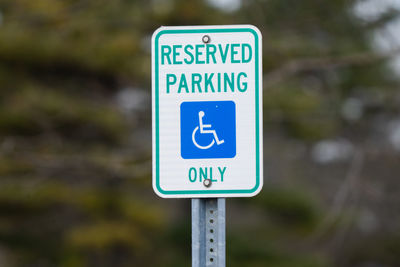 Handicap sign reserves parking for handicap only has been mounted in a public park