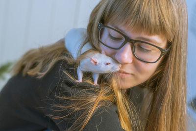 Close-up of smiling girl with rat