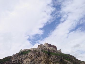 Low angle view of building against cloudy sky
