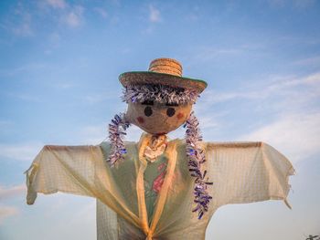 Low angle view of scarecrow against sky