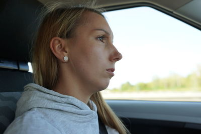 Portrait of teenage girl sitting in car