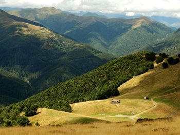 Scenic view of mountain ranges against cloudy sky