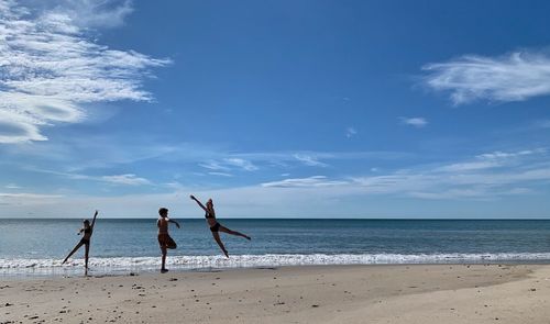 People on beach against sky