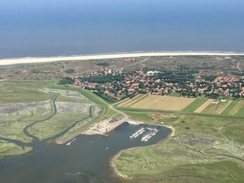 Aerial view of city and river against sky
