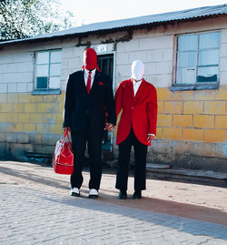 Rear view of people walking on street