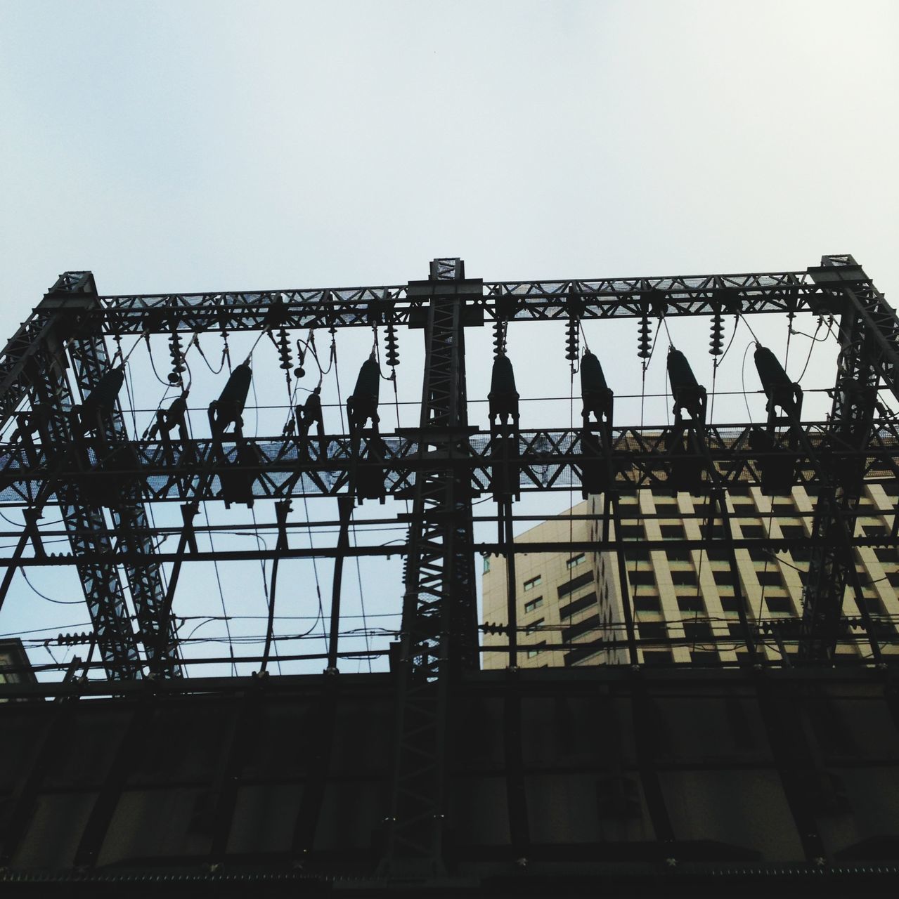 low angle view, architecture, built structure, building exterior, clear sky, window, building, sky, text, outdoors, day, no people, city, western script, copy space, glass - material, residential building, wall - building feature, roof, metal