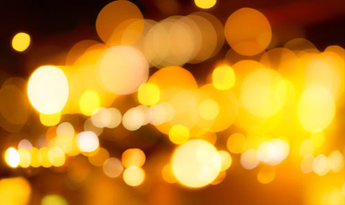 Defocused image of illuminated christmas lights at night