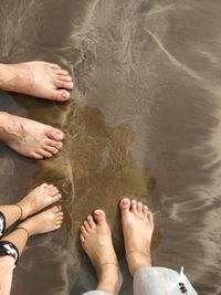 Low section of men standing in water