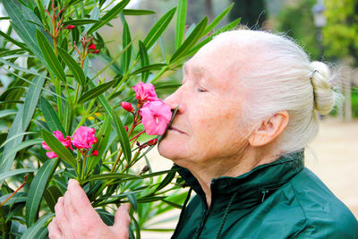 Close-up of woman with pink flower