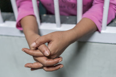 Close-up of girl hands on table