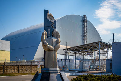 Low angle view of factory against clear sky