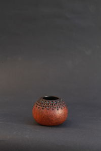 Close-up of fruit on table against black background