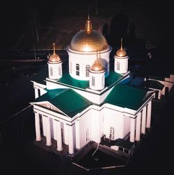 High angle view of illuminated lamp by building at night