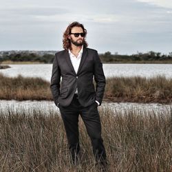 Portrait of young man standing on field
