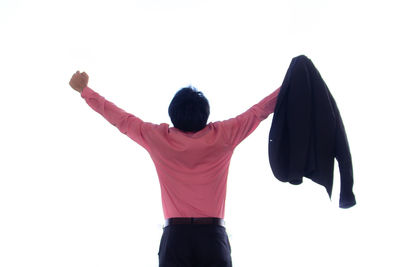 Rear view of woman standing against white background