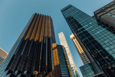 Low angle view of modern buildings against clear sky in city