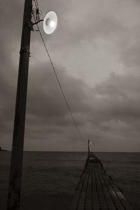 Scenic view of pier over sea against sky at dusk