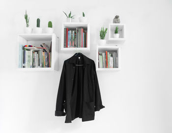 Open book on shelf against white background