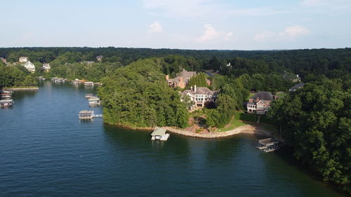 High angle view of river amidst trees against sky